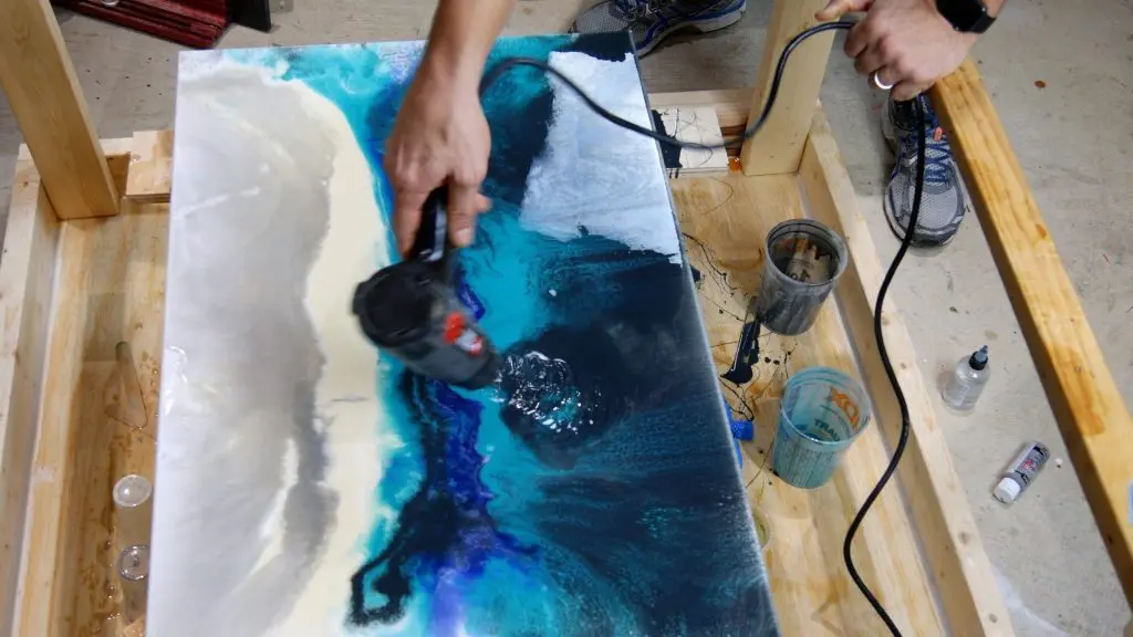 heat gun to blend resin on canvas
