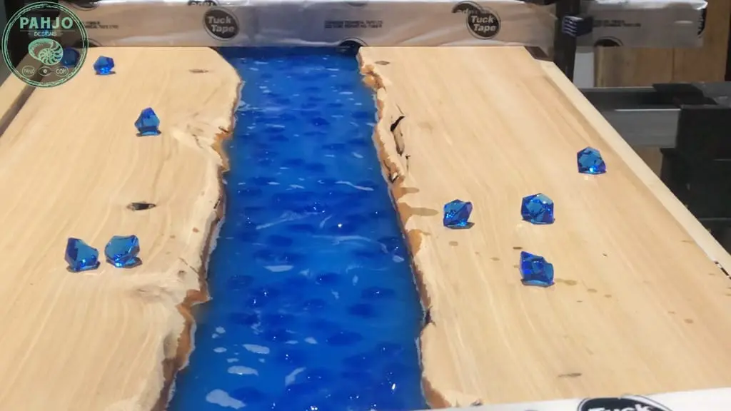 add acrylic rocks to epoxy river table