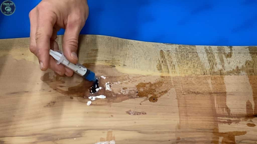 fill wood knots with blue epoxy